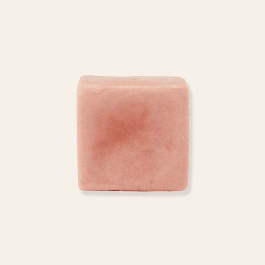 A pink solid shaving bar made with rose clay.